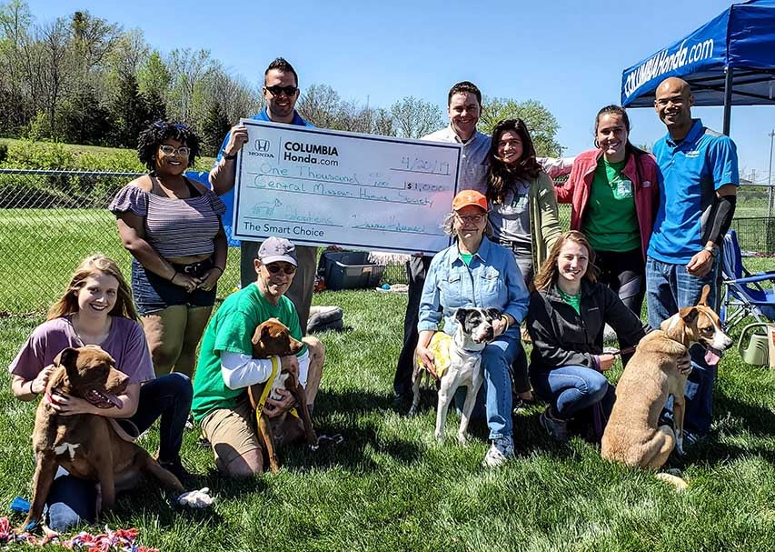 image of employees at Columbia Honda holding up a check